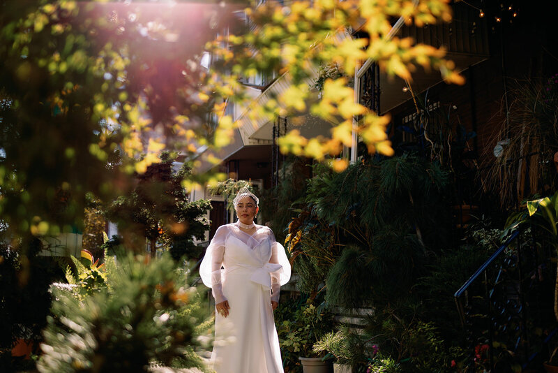 bridal portrait framed by flowers and trees outside