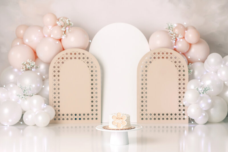 One year old Tampa baby enjoying a personalized luxury cake smash session with elegant decorations