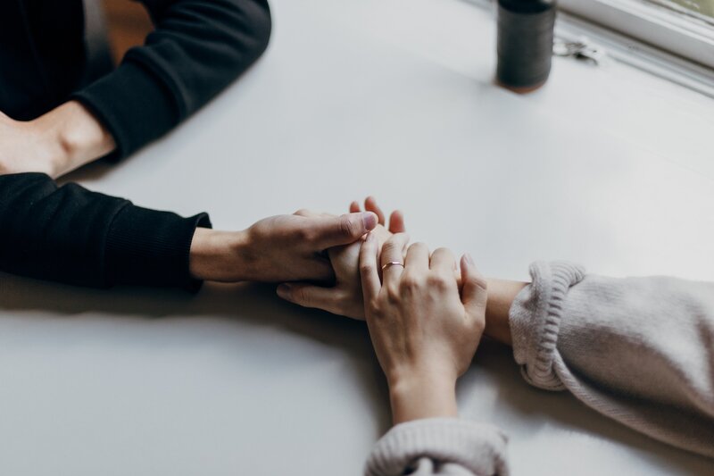 Couple holding hands across a table