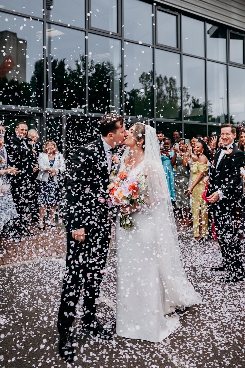 Couple kissing in Confetti shot in Manchester city centre wedding