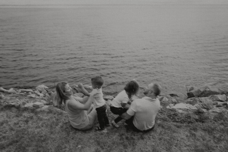 Family sitting by lake at Rip Van Winkle Gardens
