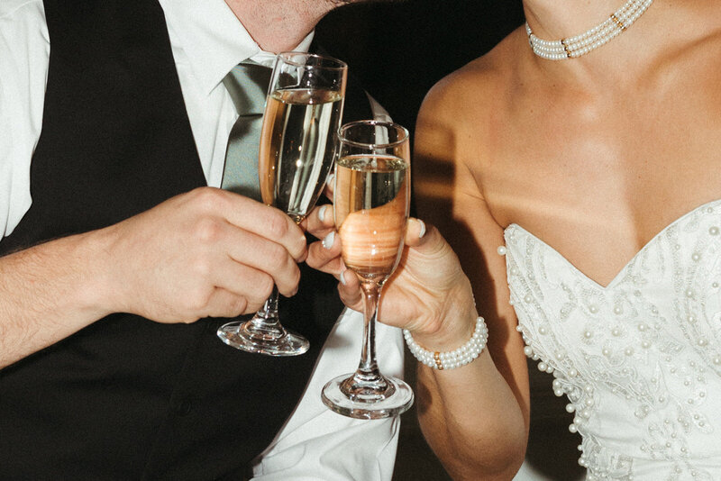 bride and groom toast with champagne glasses