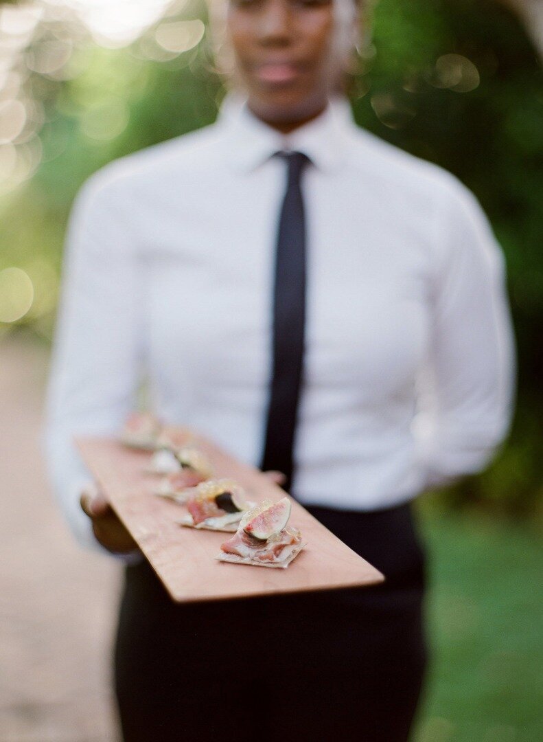 Server with a platter of appetizers