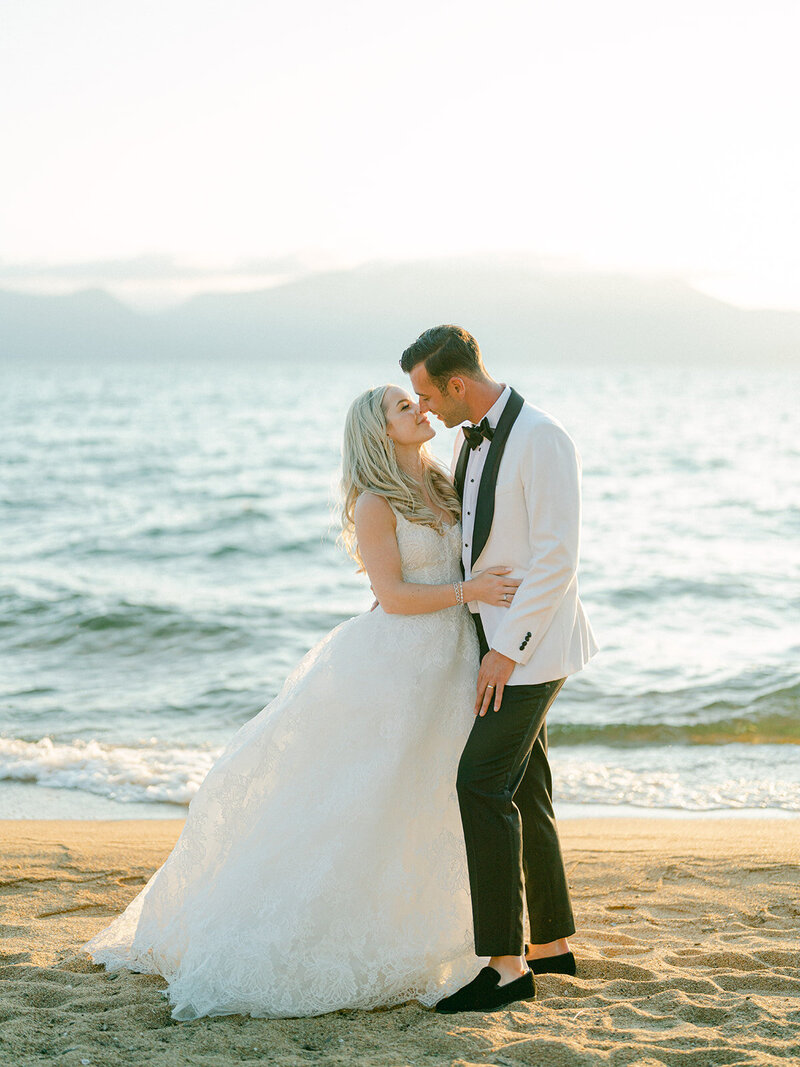bride and groom about to kiss at sunset in front of Lake Tahoe
