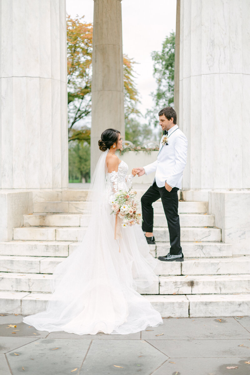 bride and groom couple standing on steps of memorial in washington dc  by costola photography