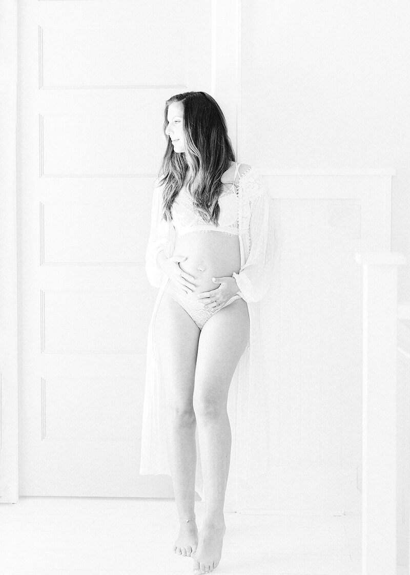 newborn baby boy photographed at home on a simple white backdrop