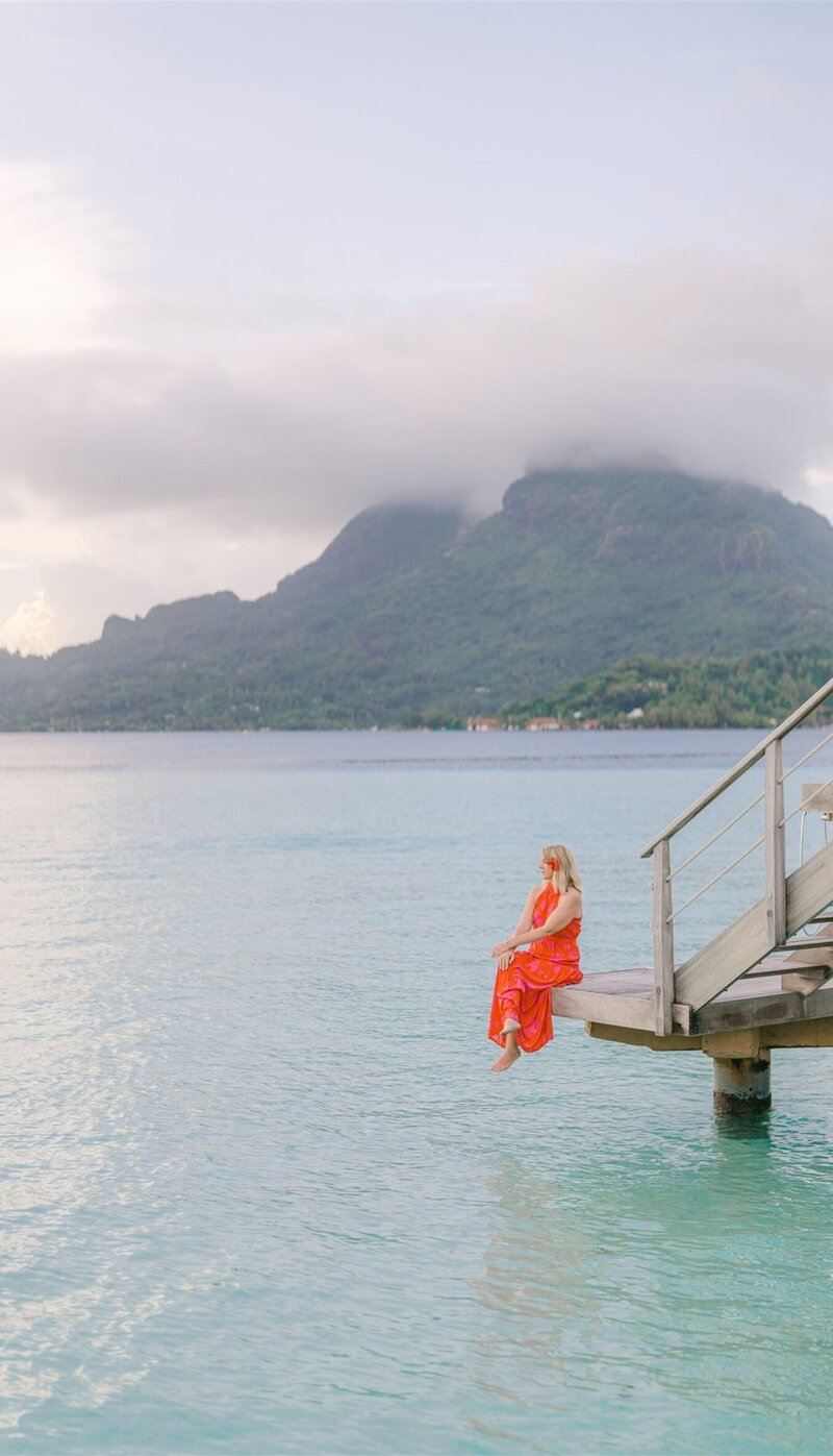 Traveler relaxing on a dock in Bora Bora, inspiring destination travel