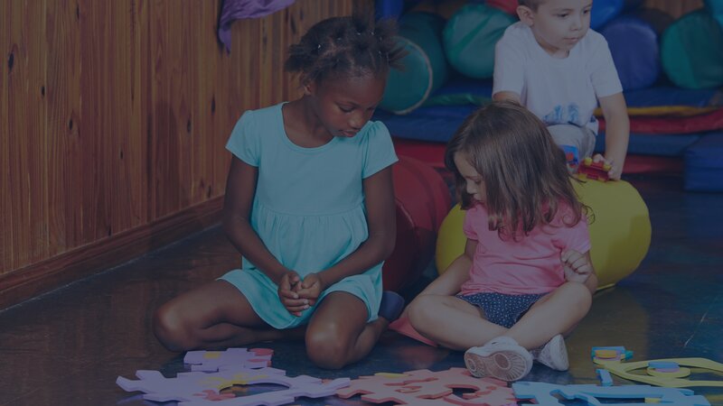 Two young girls playing together during a supervised visitation session, showing child resilience in visitation and positive connection.