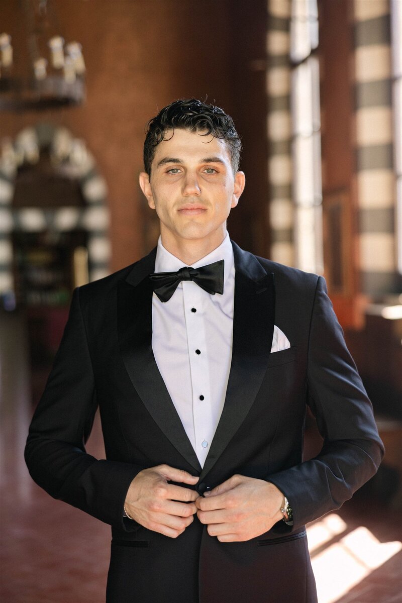 A refined groom portrait taken at the historic Brophy Chapel in Phoenix, Arizona. With warm natural light and classic composition, this image captures timeless wedding style with a subtle editorial edge.
