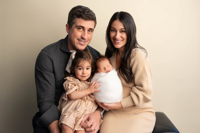 Fairfield Newborn photographer Drea S Photo captures beautiful family of our holding a newborn baby boy at Connecticut Newborn studio