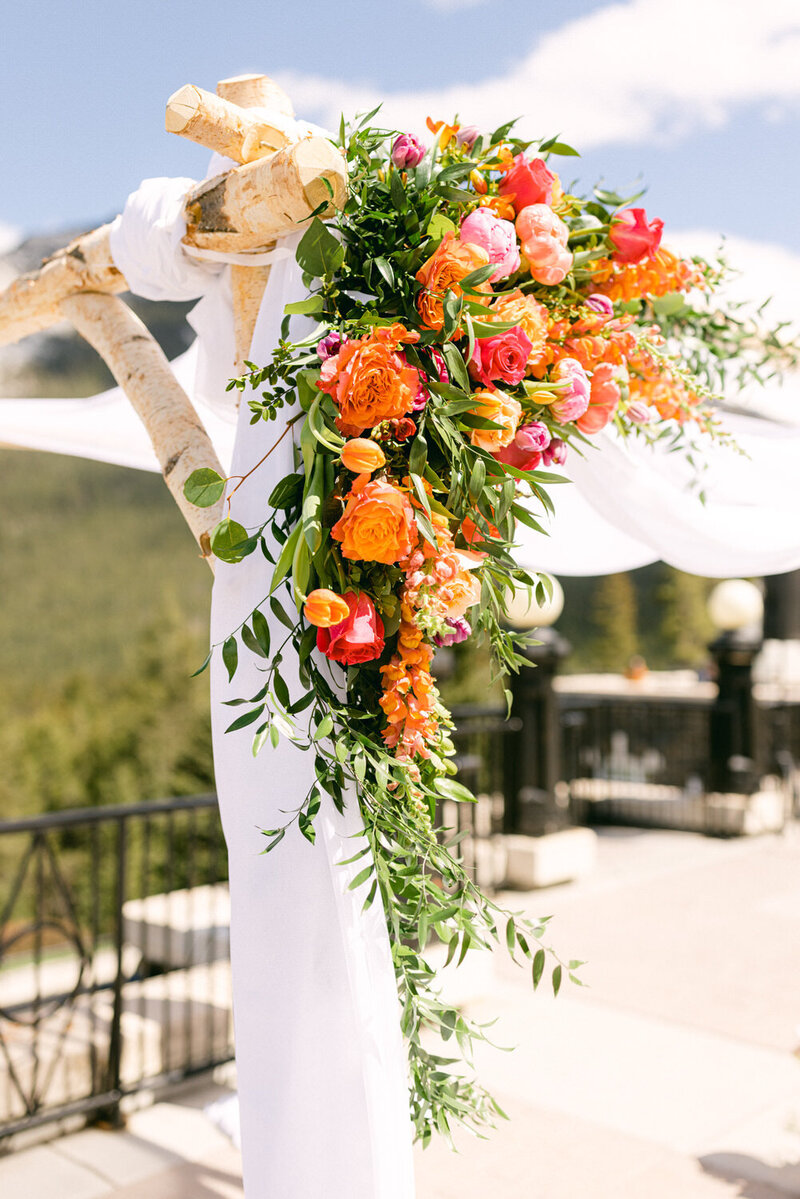 Capture the beauty of the ceremony flower arrangements on the terrace of Banff Springs Hotel. A stunning detail that adds elegance and charm to your special day.