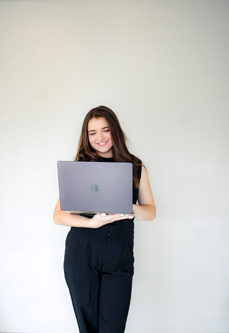 Leilah Smiling At Computer on White Background