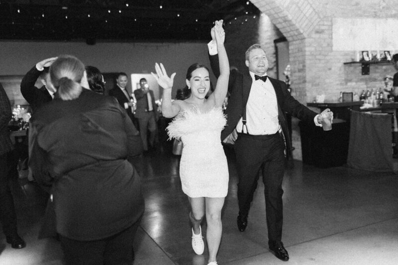 couple entering reception dancing
