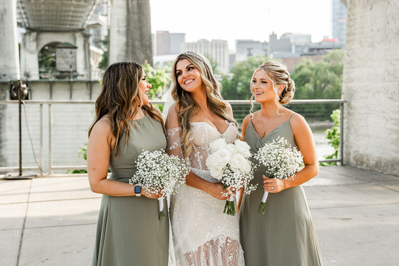 Bride with two bridesmaids holding simple white bouquets