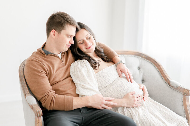 Pregnant woman sits in a chair in Kristie Lloyd's studio
