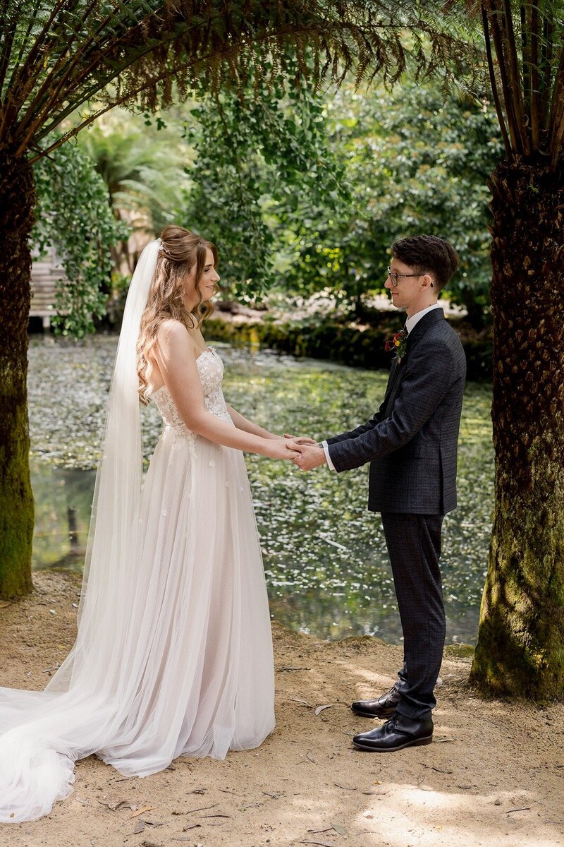 Bride and groom kissing at their micro wedding overlooking the ocean