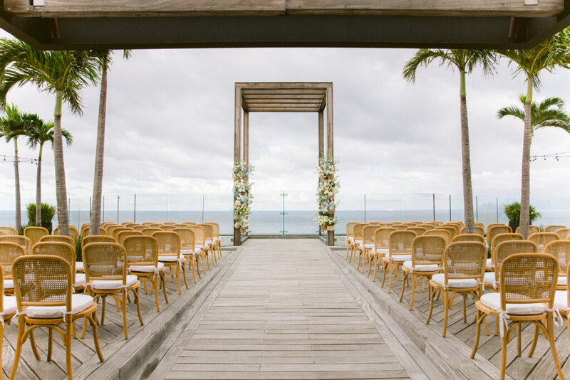 Beachfront wedding ceremony setup at Secrets Moxché in Playa del Carmen with gold chairs and ocean views