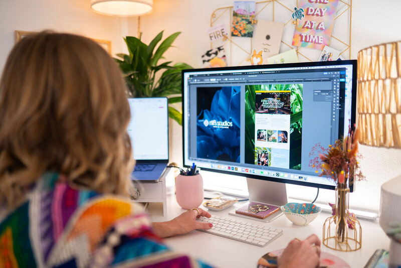 Brand and Showit Website Designer Micaela building a website at her desk - Create & Wander