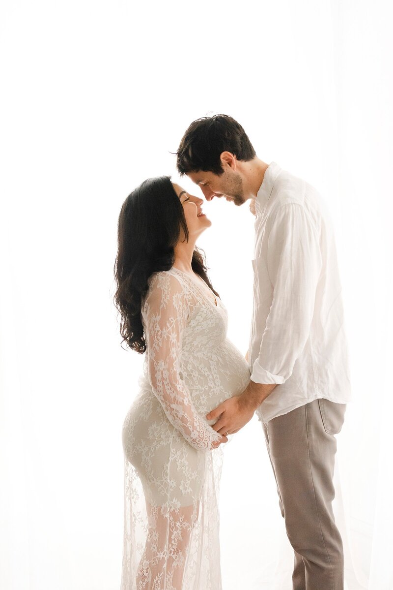 expecting parents looking at each other taken by boston maternity photographer