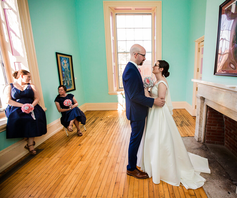 Bride and groom wait for teh start of their Erie Art Museum wedding