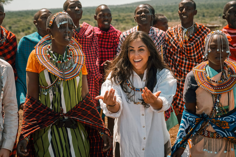 Smiling Woman dancing with Maasai tribe