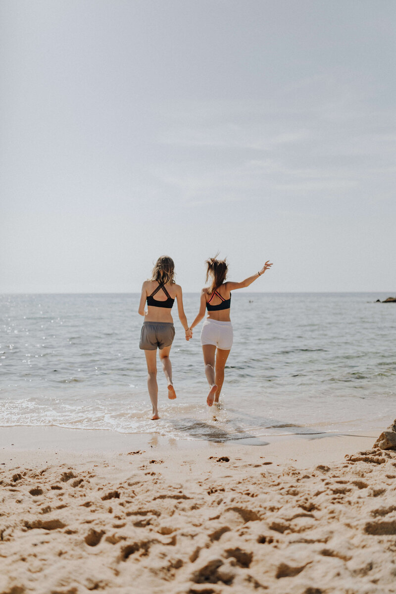 Two women running at the beach