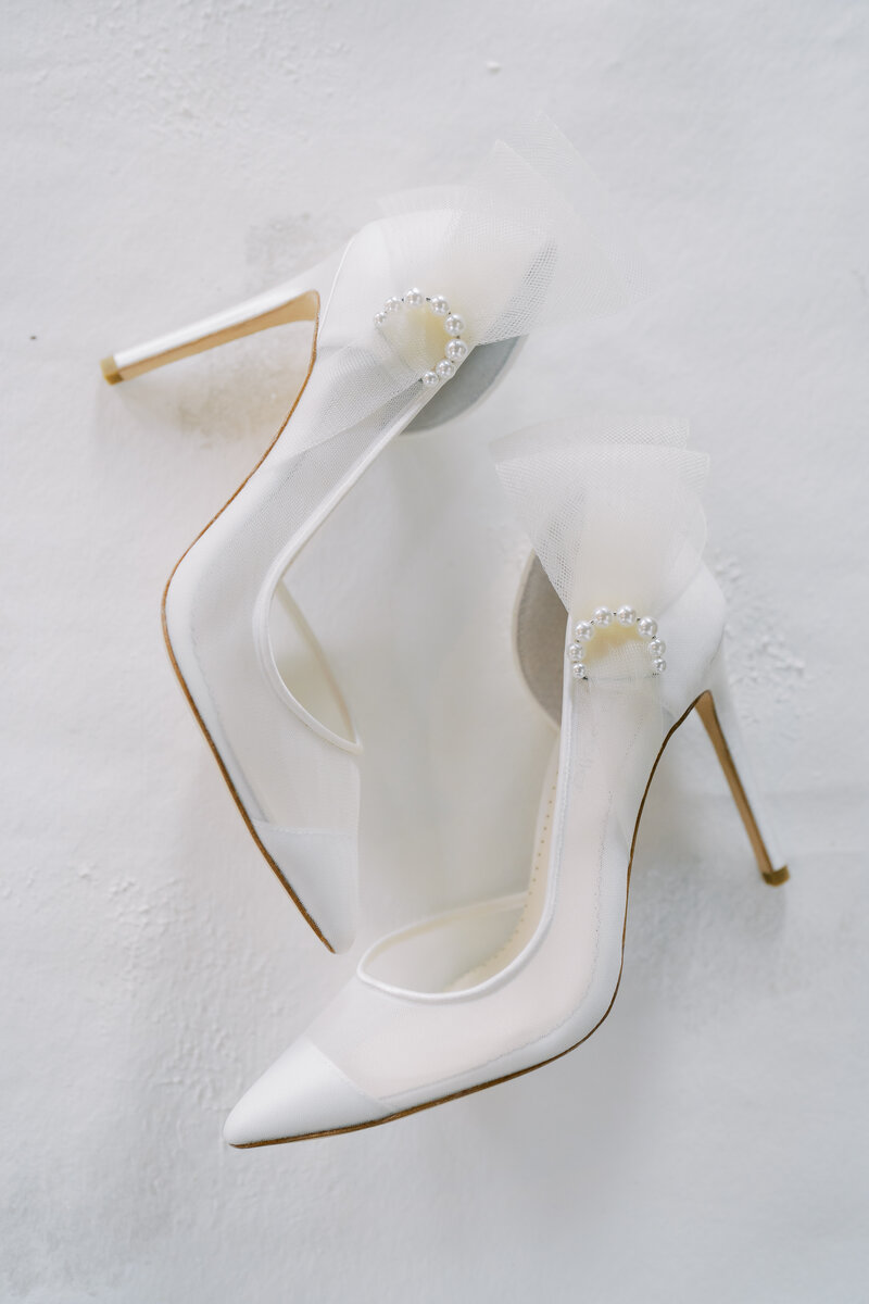 White bridal shoes on a white backdrop