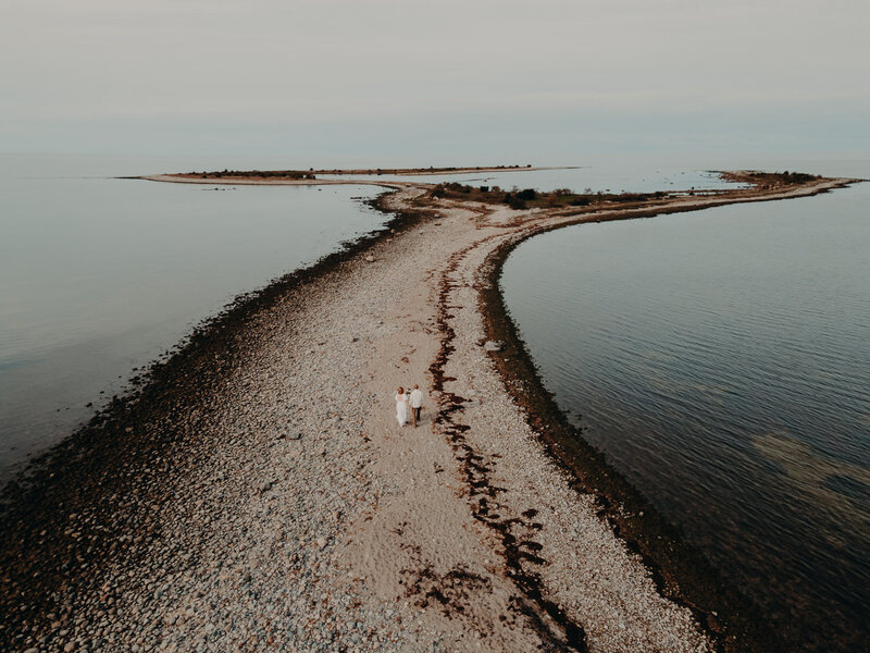 Drone photography of a wedding couple walking on a beach in Norway