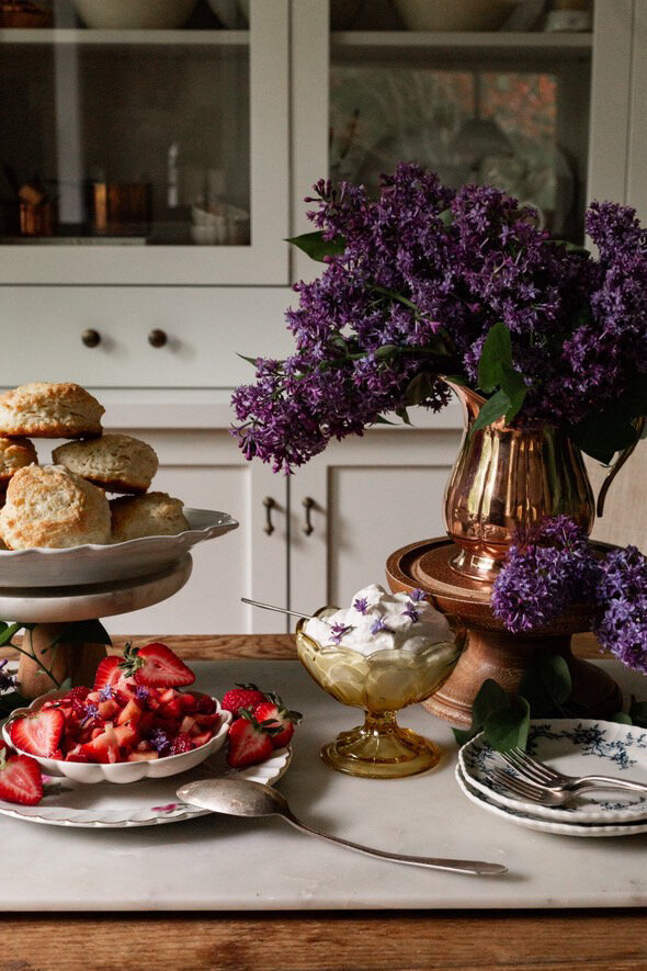 Coppermill Kitchen small pitcher with purple flowers and table decorated with food