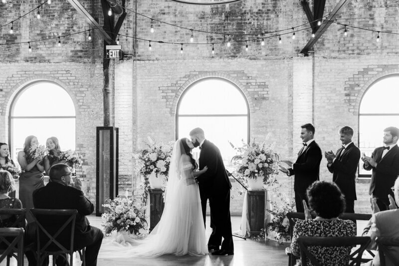 Bride and groom's first kiss during their Michigan wedding ceremony.
