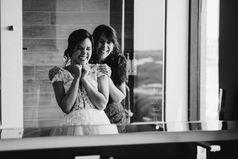 Couple sitting on front steps of a house kissing, Austin elopement wedding