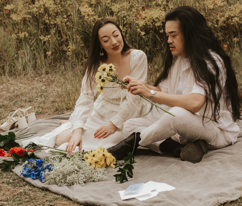 Couple arranging flowers in a romantic couple shoot in the mountains. Cinematic, storytelling photographer. 