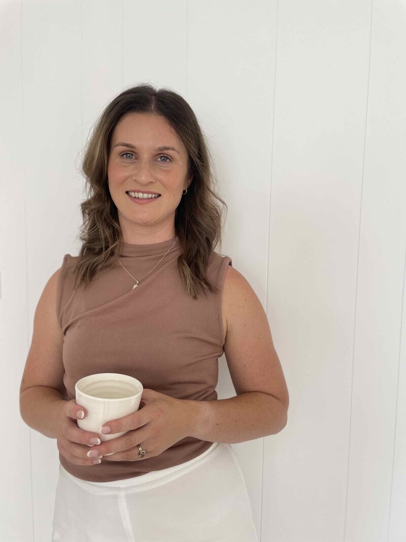 Founder Hayley smiling holding her belnd