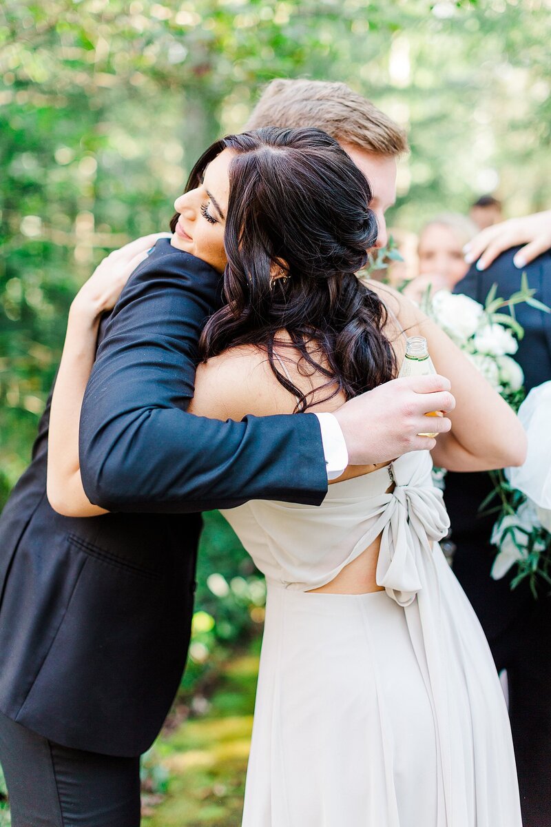 bridesmaid hugging groom by Knoxville Wedding Photographer, Amanda May Photos