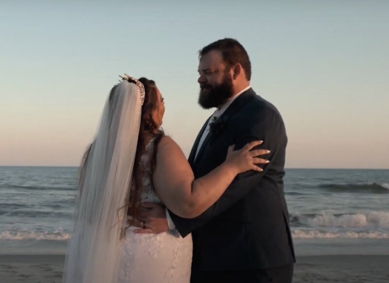 A newlywed couple dancing on the beach 