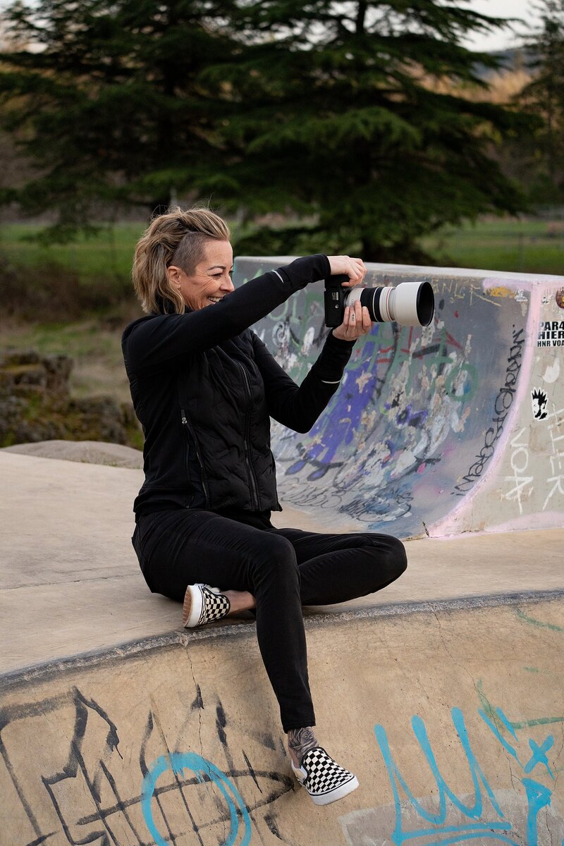 Oregon photographer with tattoos smiling at camera