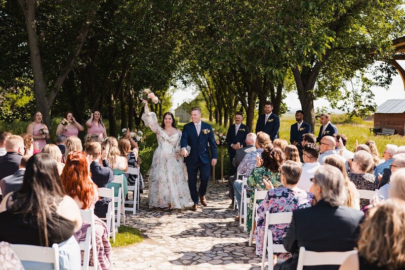 Couple celebrating their marriage as they walk down the aisle.