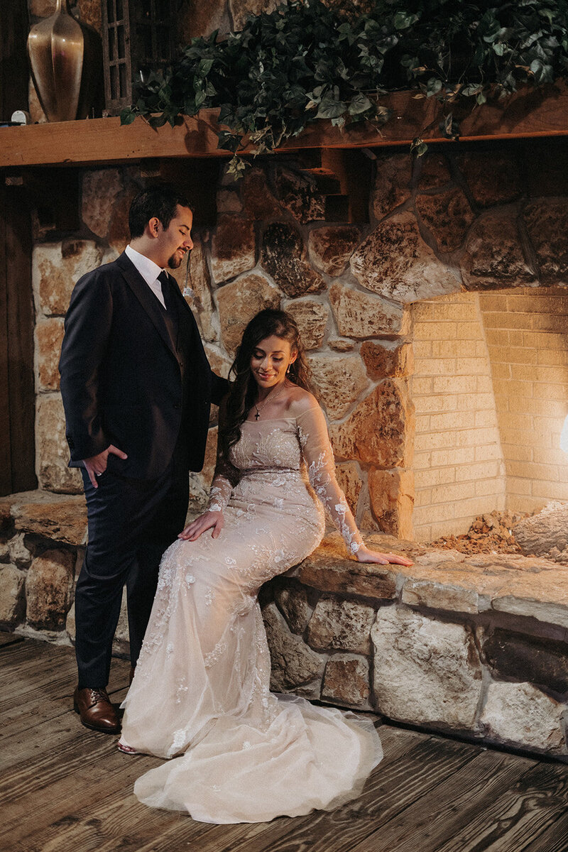destination wedding sitting by glowing fireplace