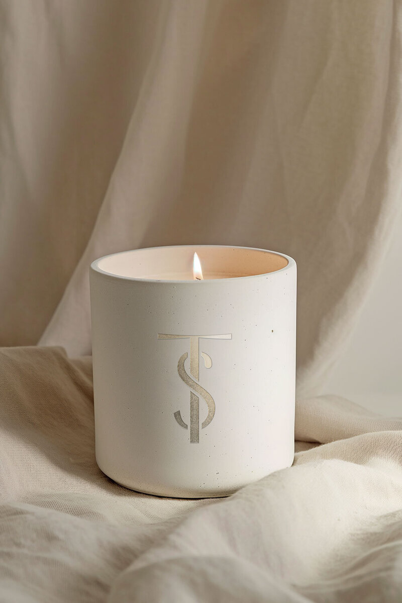 Stone-textured candle mockup with Toska Spa monogram, representing calm and luxury