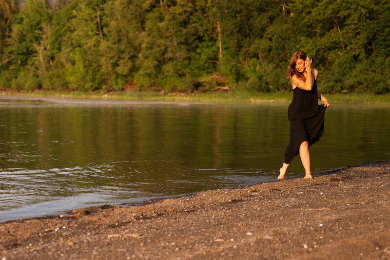 yoga teacher walking along a river bank