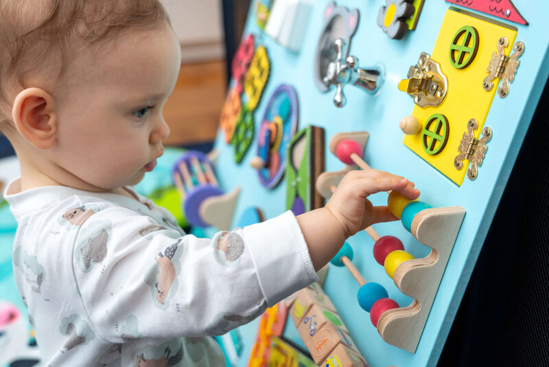 toddler playing with large interactive toy 