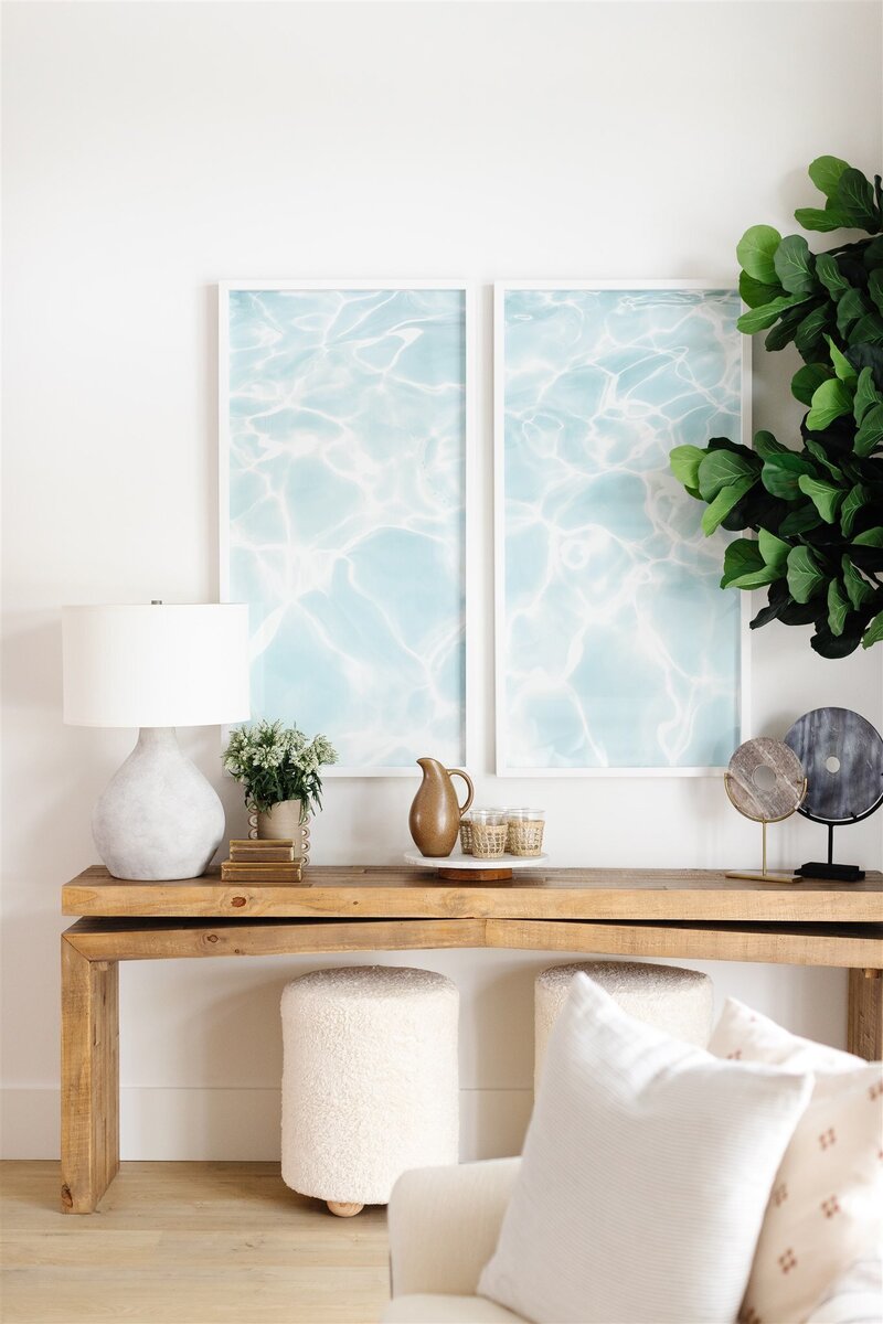 Accents on wooden sideboard with ocean water photos