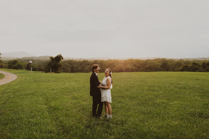 bride and groom standing in grass