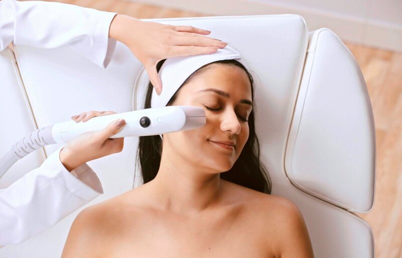 White, brunette woman getting her bespoke luxury Sofwave treatment inside Li Medical Aesthetics.