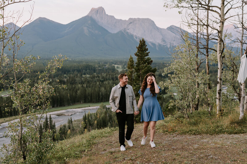 A couple walking along a mountain trail near the Pomeroy Kananaskis Mountain Lodge in Kananaskis Country, Alberta