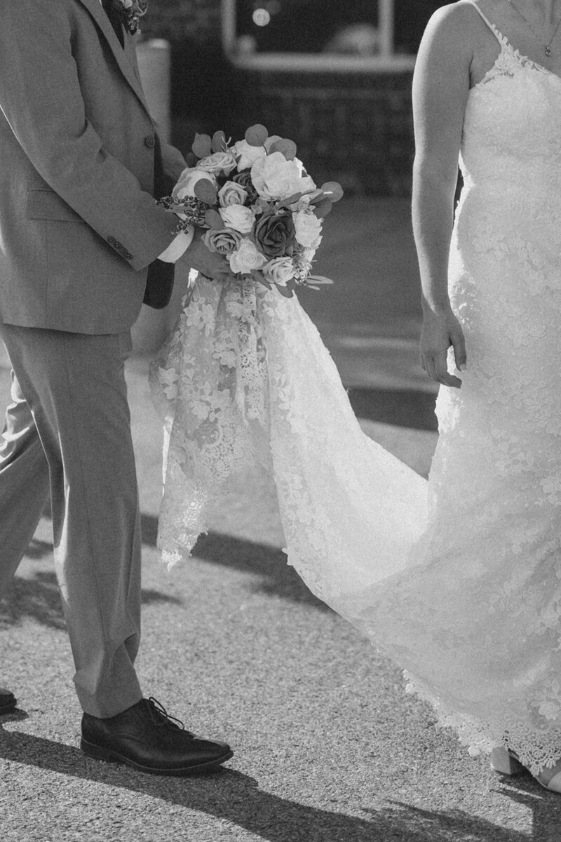 Groom holding Bride's Bouquet at Pennsylvania Rooftop Wedding