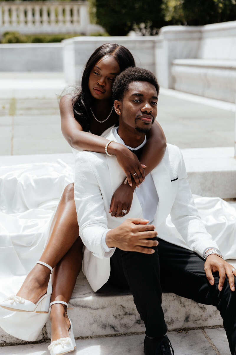 Bride and groom portraits sitting on stairs at Cleveland Museum of Art. 