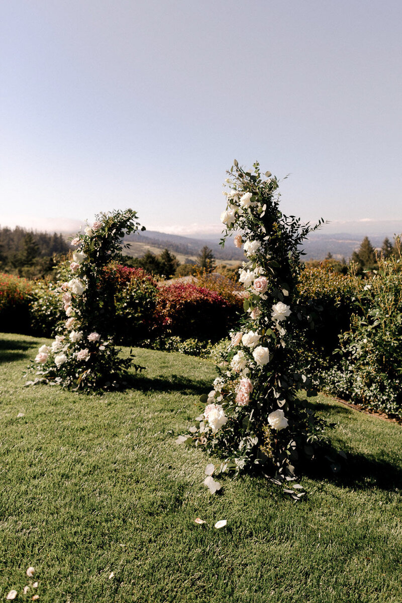 Outdoor wedding arch decorated with flowers