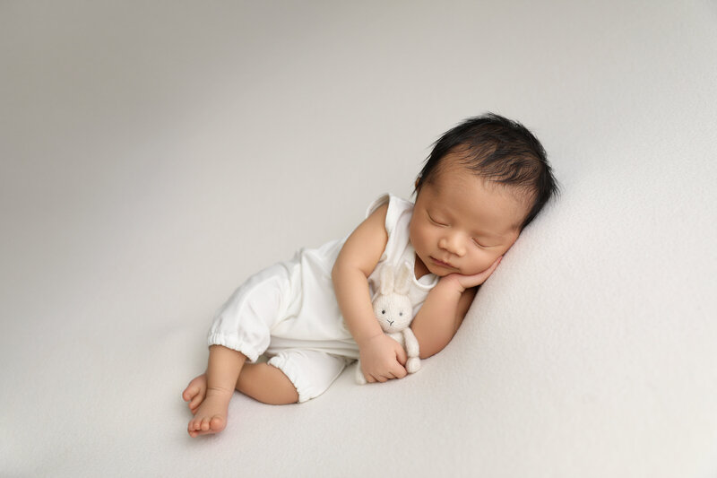 newborn boy with stuffy rabbit photographer orange county