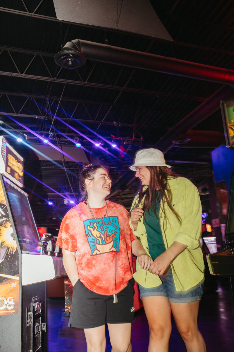 two girls laughing in an arcade